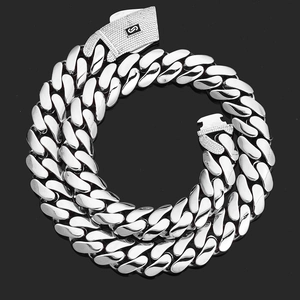 Close-up of polished silver Cuban link chain with a diamond-encrusted box clasp and S logo