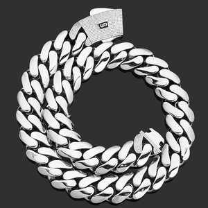 Detailed close-up of thick silver Cuban link chain with zircon-studded square S buckle