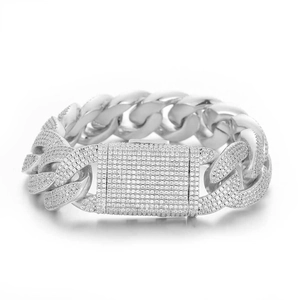 Detailed macro view of 20mm silver Cuban link bracelet with iced out zircon pavé setting