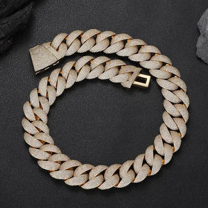 Macro detail of 24mm gold Cuban link chain with encrusted pavé Moissanite stones