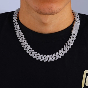Close-up of iced out silver Cuban link chain with three rows of sparkling moissanite