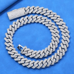 Macro shot of silver hip-hop cuban link necklace with triple rows of full zircon pave