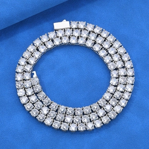 Macro detail of silver-tone three-row round-cut tennis chain necklace with secure clasp