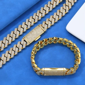 Close-up of gold cuban link necklace and bracelet set with iced out zircon stones
