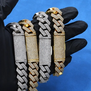 Close-up of hip-hop iced out Cuban link necklaces with diamond rectangle plates in gold and silver