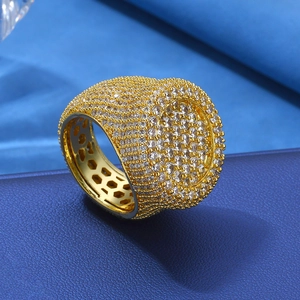 Detail of gold hip hop ring with iced out crystals and honeycomb interior mesh