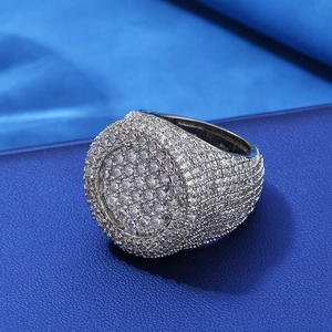 Macro shot of silver hip hop ring featuring pave-set round cubic zirconia diamonds