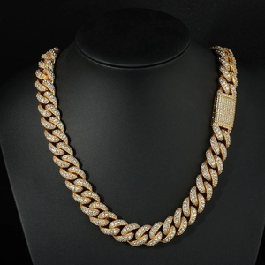 Macro shot of gold hip hop Cuban link chain with full zircon paving on black neck bust