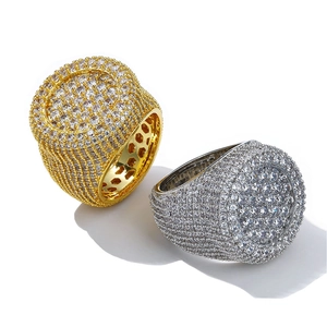 Detailed macro view of gold and silver iced-out hip hop rings with full pavé zircon stones