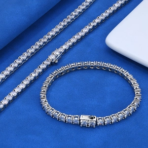 Detailed view of silver tennis necklace and bracelet set with round-cut stones
