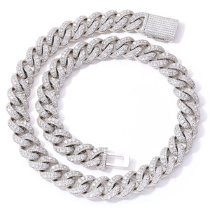 Macro shot of silver S925 sterling silver Cuban link chain with icy pave moissanite stones