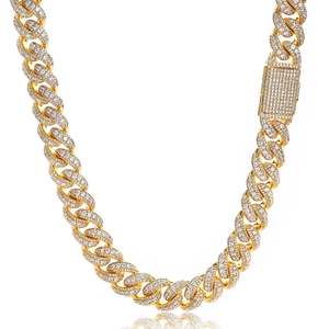 Close-up of gold Cuban link chain with pave-set moissanite and heavy rectangular clasp