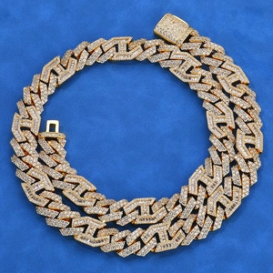 Macro shot of gold hip hop chain with 15mm diamond-cut geometric links and CZ stones