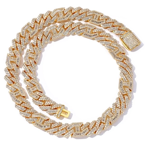 Macro shot of gold hip hop Cuban chain featuring pave-set round and baguette stones