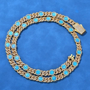 Detailed close-up of Cuban link necklace featuring blue opal stones and white zircons