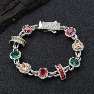 Detail eines Luxus-Armbands mit bunten Edelsteinen und Zirkon-Besatz auf schwarzem Grund