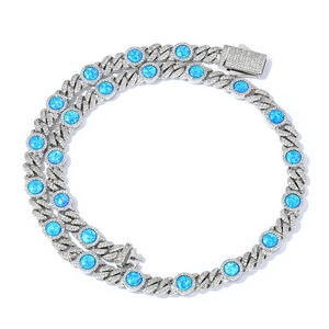 Close-up of silver Cuban link chain with micro-paved zircon and round blue opal stones