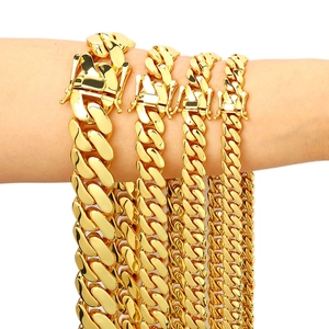 Detail view of four gold Cuban link chains in varying widths with secure box clasps
