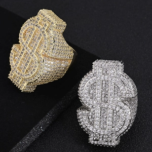Macro detail of gold and silver dollar sign hip hop rings with iced out zircon stones