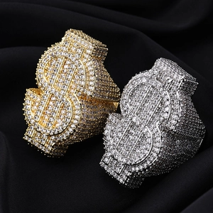 Macro shot of iced out dollar sign rings with sparkling pavé set cubic zirconia stones