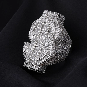 Macro shot of silver hip-hop dollar sign ring with sparkling full pavé set stones
