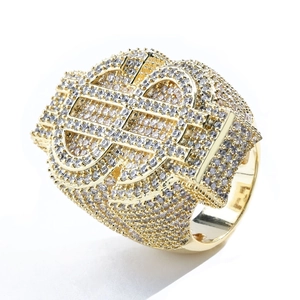 Macro shot of gold hip hop ring featuring dollar sign pattern with white cubic zirconia