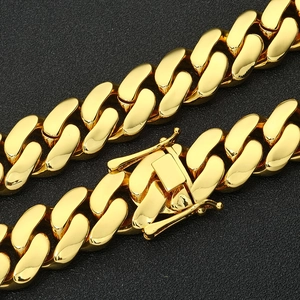 Detail of a polished golden cuban link chain featuring a secure box clasp mechanism
