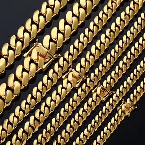 Detail of five golden polished Cuban link chains in various widths with secure box clasps