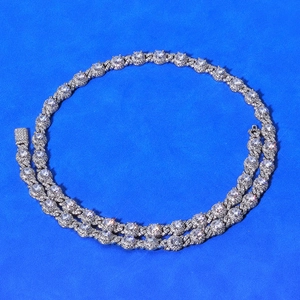 Macro shot of silver hip hop Cuban chain featuring round cluster zircon pavé links
