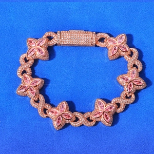 Detail of rose gold infinity link bracelet with pink gems on blue background