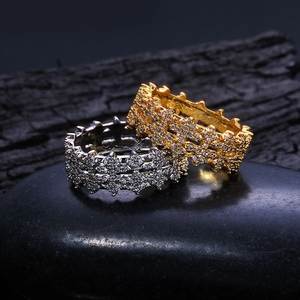 Macro detail of gold and silver 8mm iced out pave rings on charcoal stones