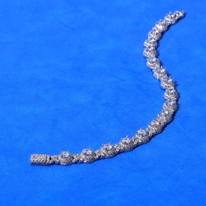 Macro detail of silver-tone tennis bracelet with shimmering pave-set cubic zirconia stones