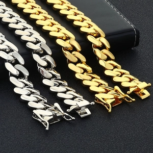 Detailed view of Cuban link chains in gold and silver with folding insurance clasps