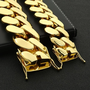 Macro shot of gold Cuban link chain with a high-quality box clasp and secure safety hinges