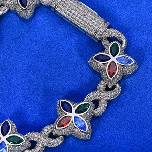 Macro detail of iced-out hip hop bracelet with infinity links and colorful gemstones