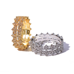 Detailed macro view of 8mm iced out gold and silver rings with pave set zircon stones