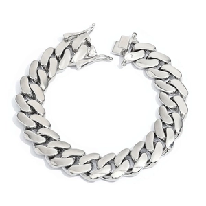 Close-up of silver polished Cuban chain bracelet featuring a heavy duty box clasp closure