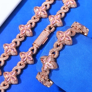 Macro view of rose gold clover bracelet with pink marquise-cut stones and pavé crystals