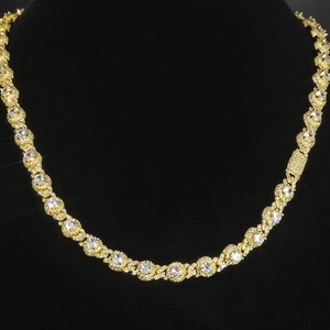 Close-up of a 7.5mm gold hip hop tennis chain with round cubic zirconia on a black bust