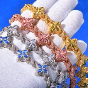 Macro detail of hip hop clover bracelets in gold, silver, and rose gold with colorful stones