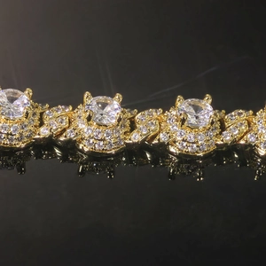 Macro detail of 18K gold-plated Cuban link chain with 7.5mm zircon crown settings