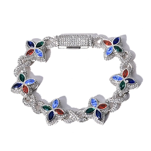 Detailed macro view of colorful zircon clover charms on iced-out Cuban link bracelet
