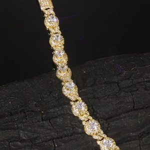 Detail of 7.5mm gold-plated Cuban link bracelet with round cubic zirconia pavé setting