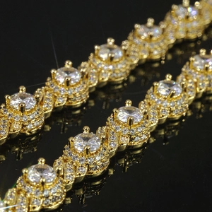 Luxurious 7.5mm gold Cuban link bracelet featuring round cubic zirconia stones on black background