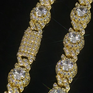 Macro view of 7.5mm gold Cuban chain with iced-out zircon pave and luxury clasp detail