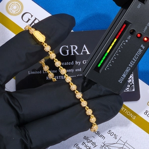 Diamond tester pen testing 4mm gold moissanite beads on a 925 silver bracelet