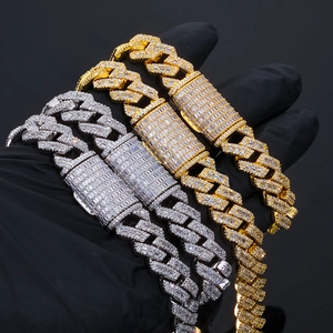 Detail of heavy 14mm silver and gold Cuban link bracelets with iced out Moissanite pavé