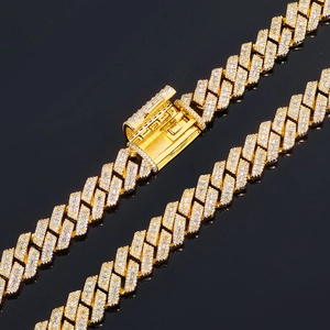 Macro shot of 14mm gold cuban link chain with paved baguette and round cubic zirconia