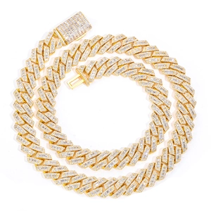 Macro detail of luxury 14mm golden Cuban link necklace with iced out baguette zircon stones