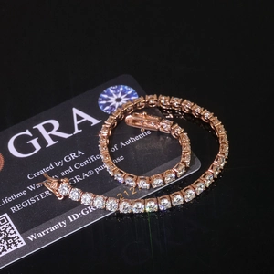 Macro shot of rose gold moissanite tennis bracelet on GRA card with secure clasp detail